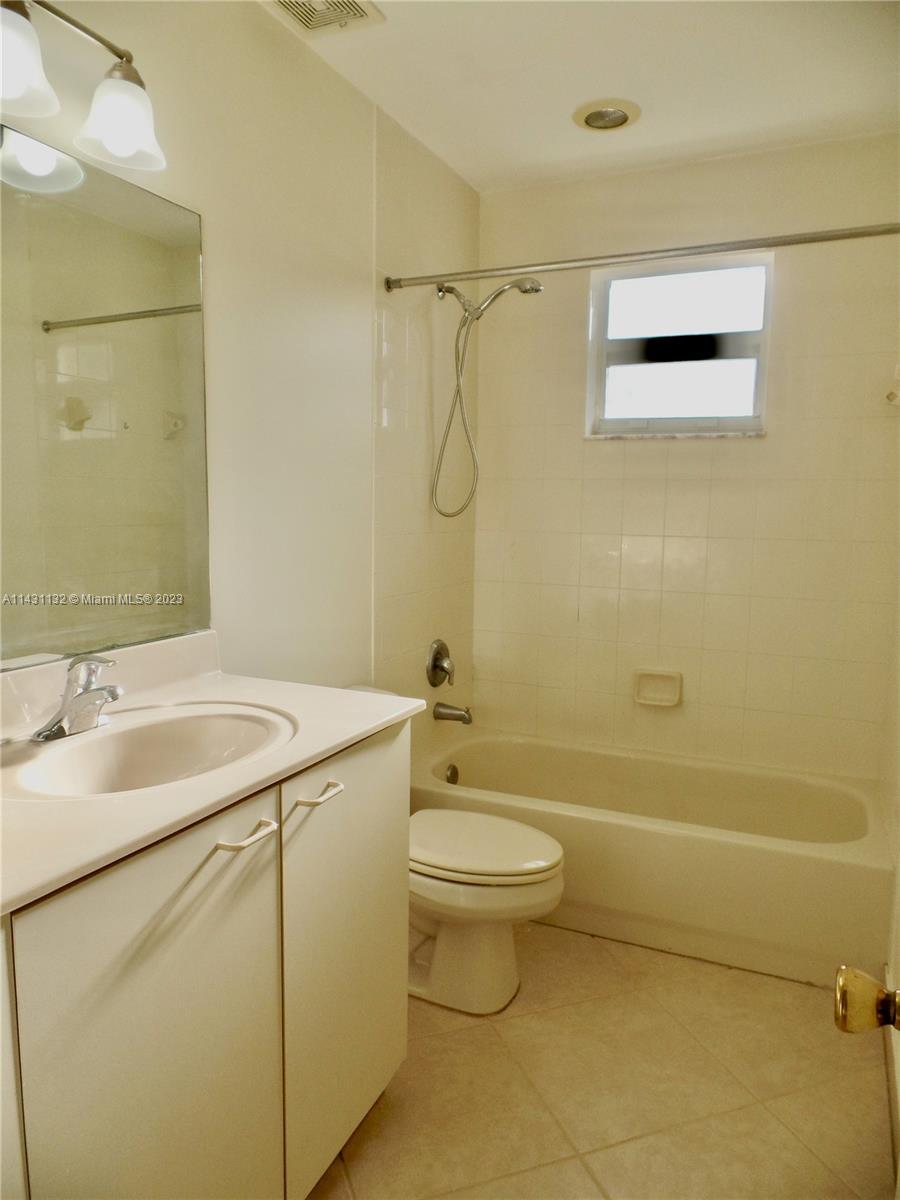 4744 Southwest 165th Avenue, Unit 4744 Miramar, FL 33027 - Photo 18 of 34 a bathroom with a sink a toilet and shower