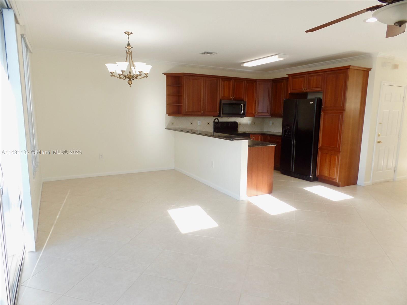 4744 Southwest 165th Avenue, Unit 4744 Miramar, FL 33027 - Photo 4 of 34 a view of kitchen with refrigerator and window