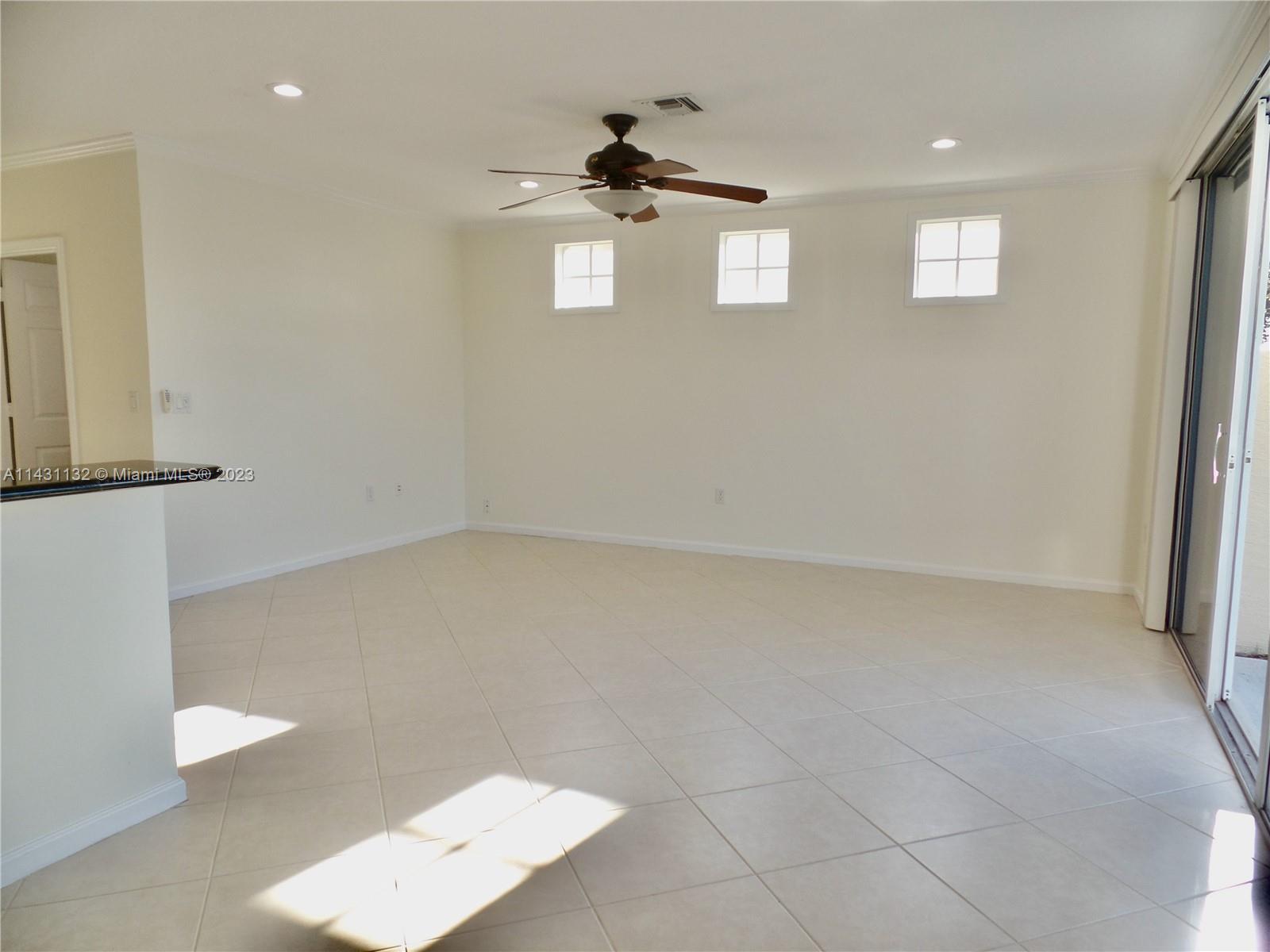 4744 Southwest 165th Avenue, Unit 4744 Miramar, FL 33027 - Photo 7 of 34 an empty room with windows and cabinet