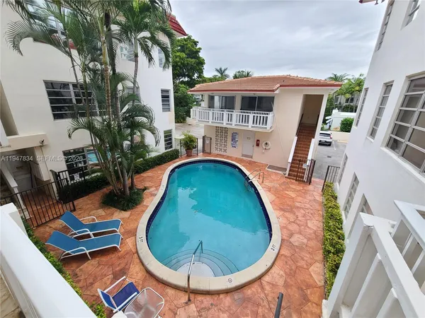 an aerial view of a house with swimming pool garden and patio