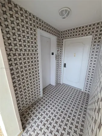 a bathroom with a black white checkered floor