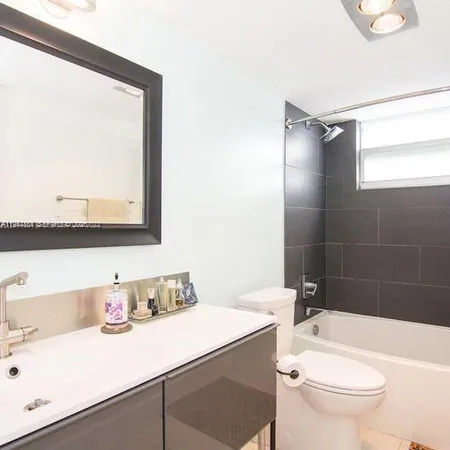a bathroom with a sink vanity and mirror