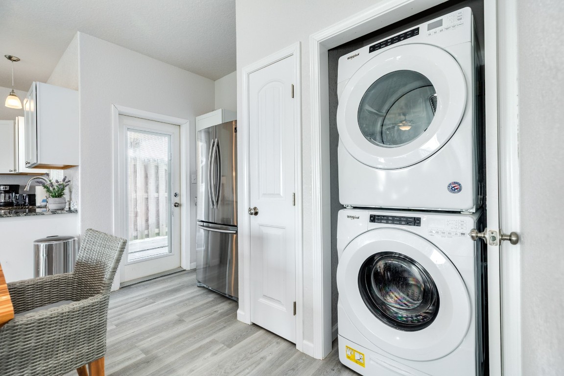 116 Howard Avenue, Unit G Surfside Beach, TX 77541 - Photo 11 of 31 a view of a hallway with washer and dryer