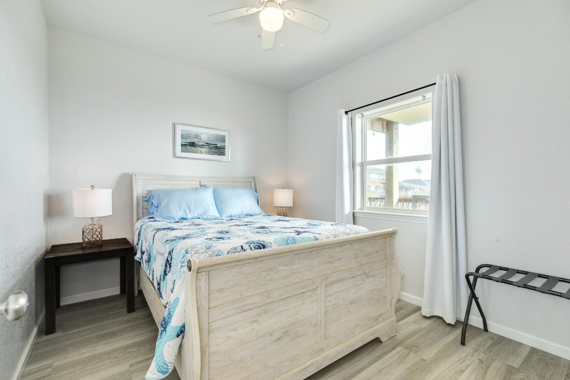 116 Howard Avenue, Unit G Surfside Beach, TX 77541 - Photo 12 of 31 a bedroom with a bed and a window