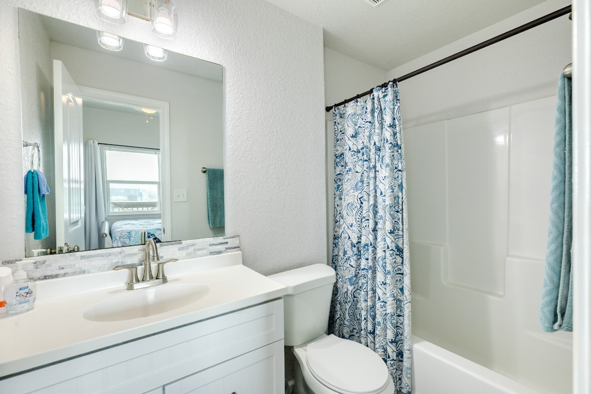 116 Howard Avenue, Unit G Surfside Beach, TX 77541 - Photo 15 of 31 a bathroom with a sink a toilet and shower