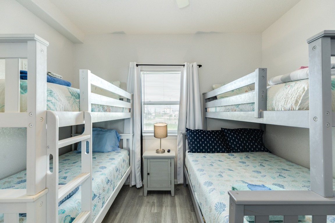 116 Howard Avenue, Unit G Surfside Beach, TX 77541 - Photo 16 of 31 a bedroom with a bed and a window