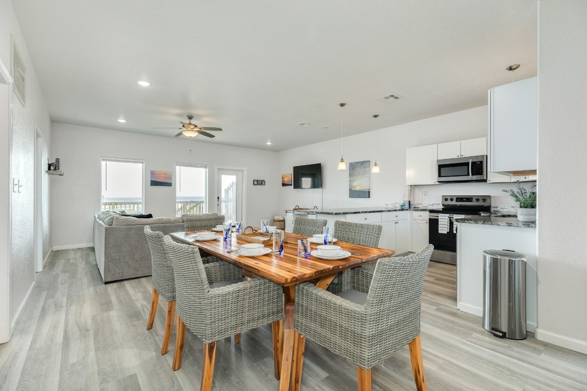116 Howard Avenue, Unit G Surfside Beach, TX 77541 - Photo 3 of 31 a view of a dining room with furniture and wooden floor