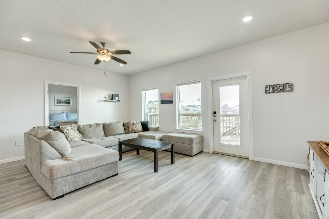 116 Howard Avenue, Unit G Surfside Beach, TX 77541 - Photo 5 of 31 a living room with furniture and a large window