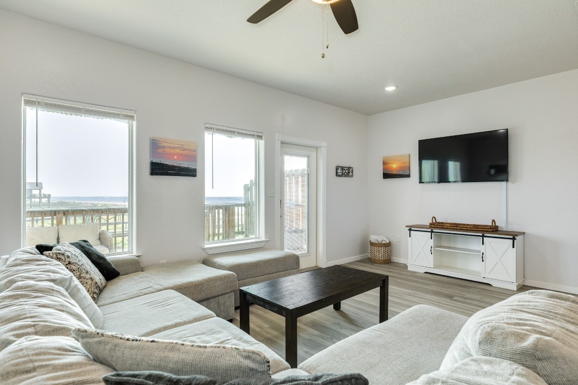 116 Howard Avenue, Unit G Surfside Beach, TX 77541 - Photo 6 of 31 a living room with furniture and a flat screen tv