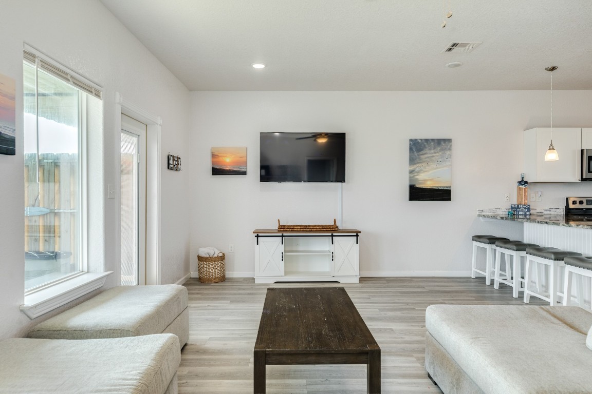 116 Howard Avenue, Unit G Surfside Beach, TX 77541 - Photo 7 of 31 a living room with furniture and a flat screen tv