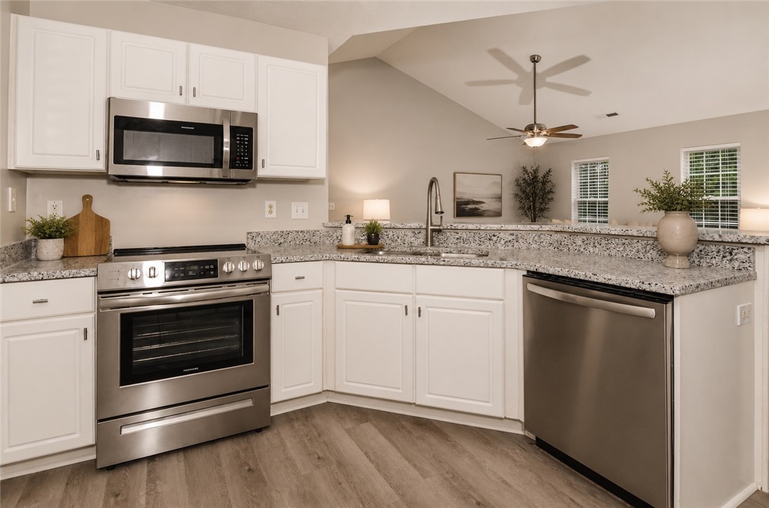 102 Hawk Ridge Drive Anderson, SC 29621 - Photo 35 of 38 This modern kitchen features durable countertops, sleek stainless steel appliances, and abundant natural light.