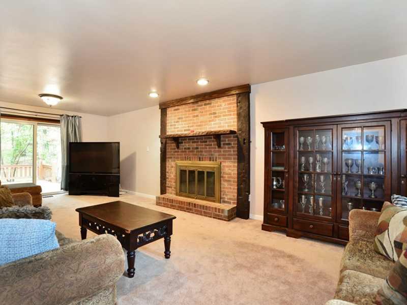 208 Woodcroft Road Economy, PA 15005 - Photo 4 of 15 Family Room. The family room is accented with a floor to ceiling brick fireplace with gas starter.