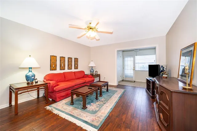 a living room with furniture and a flat screen tv with wooden floor