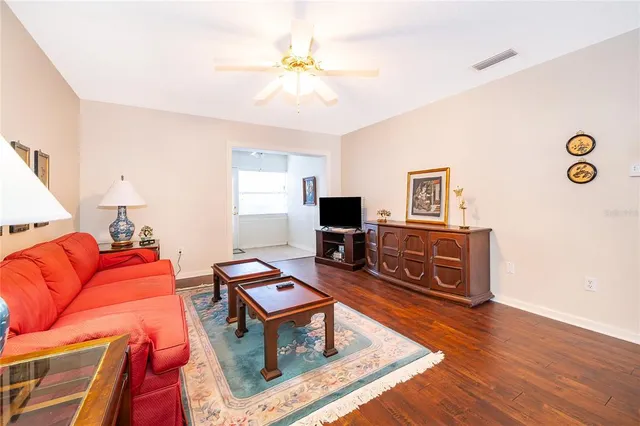 a living room with furniture a flat screen tv and a table
