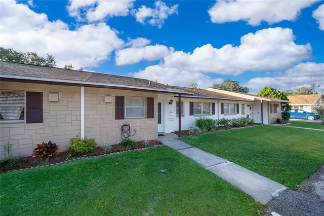 a view of a house with a backyard