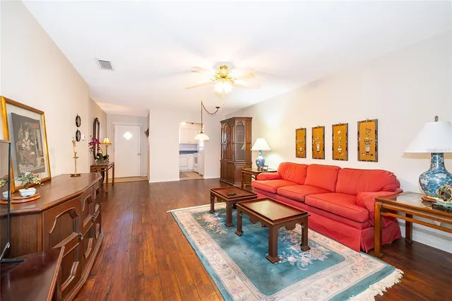 a living room with furniture a flat screen tv and a table
