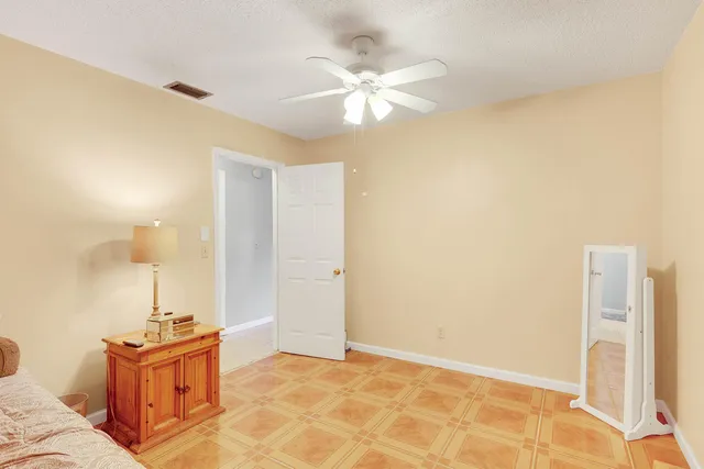 a view of a bedroom with a sink and chandelier