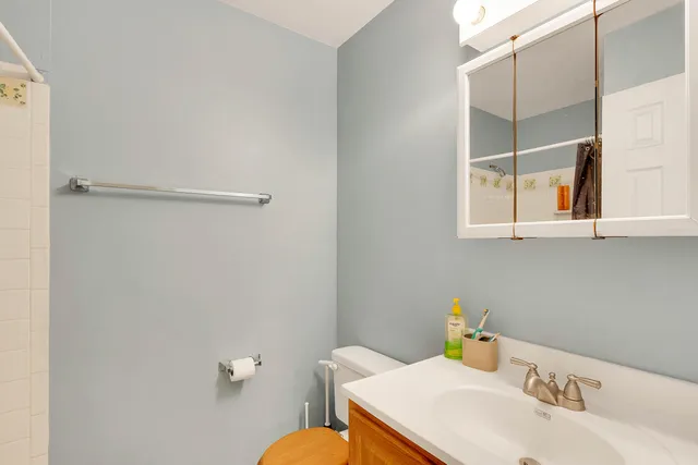 a bathroom with a sink toilet and mirror