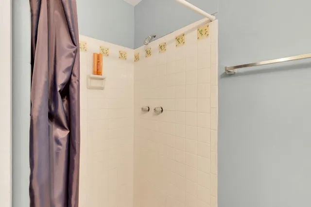 a bathroom with a shower and a shower