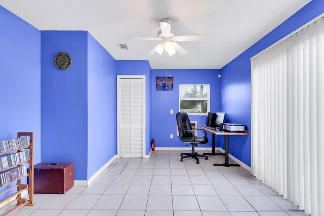 a view of a workspace with furniture and a window
