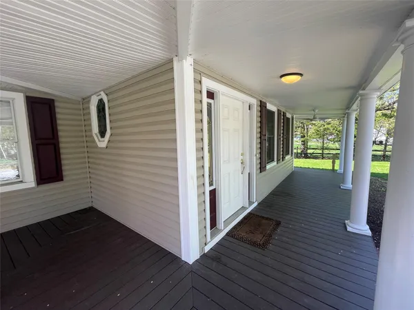 a view of hallway with wooden floor