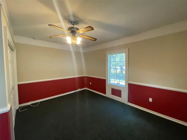 a view of room with window and ceiling fan