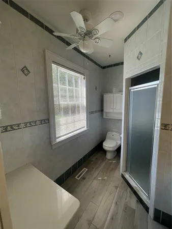 a bathroom with a toilet sink and a shower