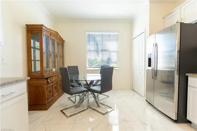 a view of a kitchen with a refrigerator and cabinets