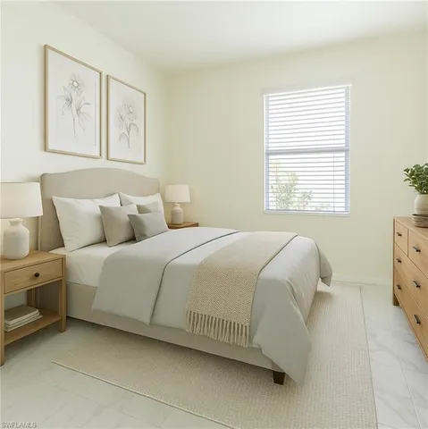 a bedroom with a bed and painting on the wall