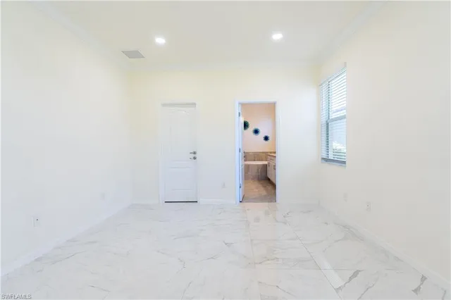 an empty room with cabinet and mirrors