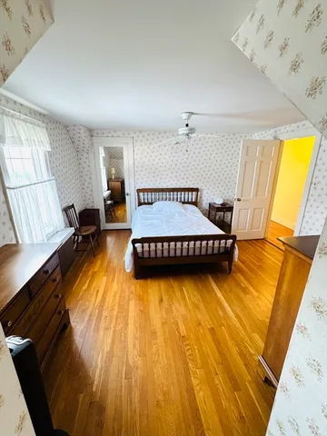 a bedroom with bed and window