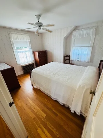 a living room with a couch wooden floor and a table