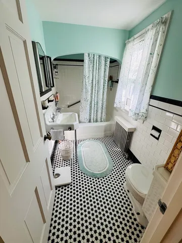 a living room with furniture and a rug