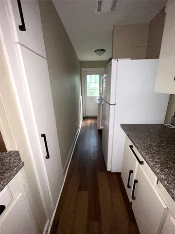 a view of a kitchen from the hallway