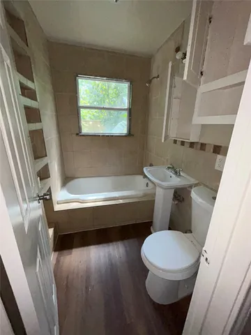 a bathroom with a toilet a sink and a bathtub