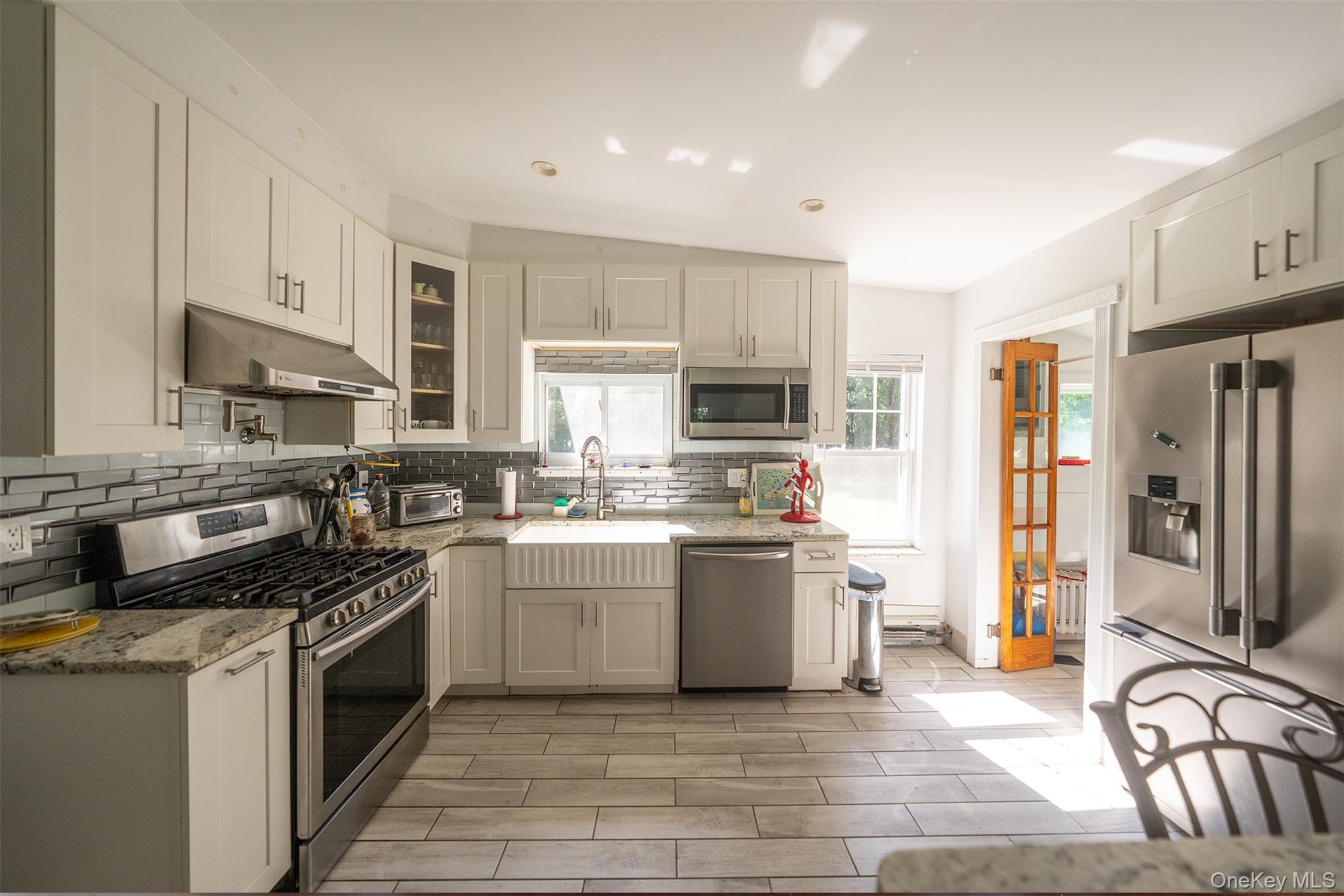 40495 Main Road Orient, NY 11957 - Photo 7 of 26 New kitchen layout with timeless finishes makes this a bright kitchen that catches the afternoon light over the kitchen sink.