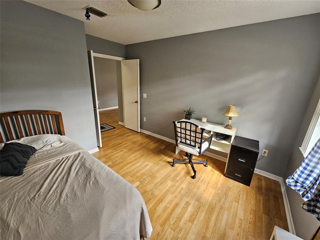 5203 Europa Drive, Unit G Boynton Beach, FL 33437 - Photo 13 of 29 a bedroom with a bed and chair