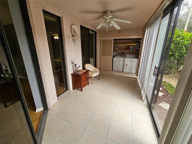 a view of a kitchen with kitchen island sink and refrigerator