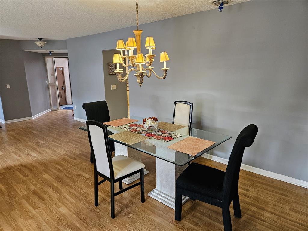 5203 Europa Drive, Unit G Boynton Beach, FL 33437 - Photo 9 of 29 a view of a dining room with furniture and wooden floor
