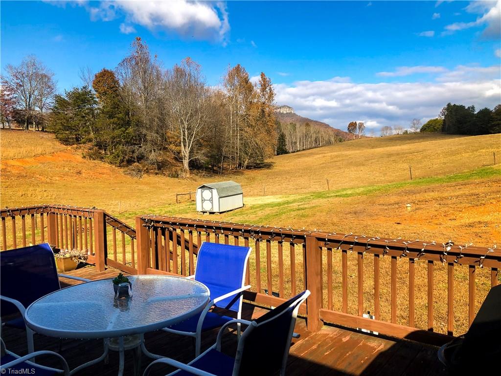 673 Mt Zion Road Pinnacle, NC 27043 - Photo 1 of 26 deck and back yard view of rolling pasture and Pilot Mtn