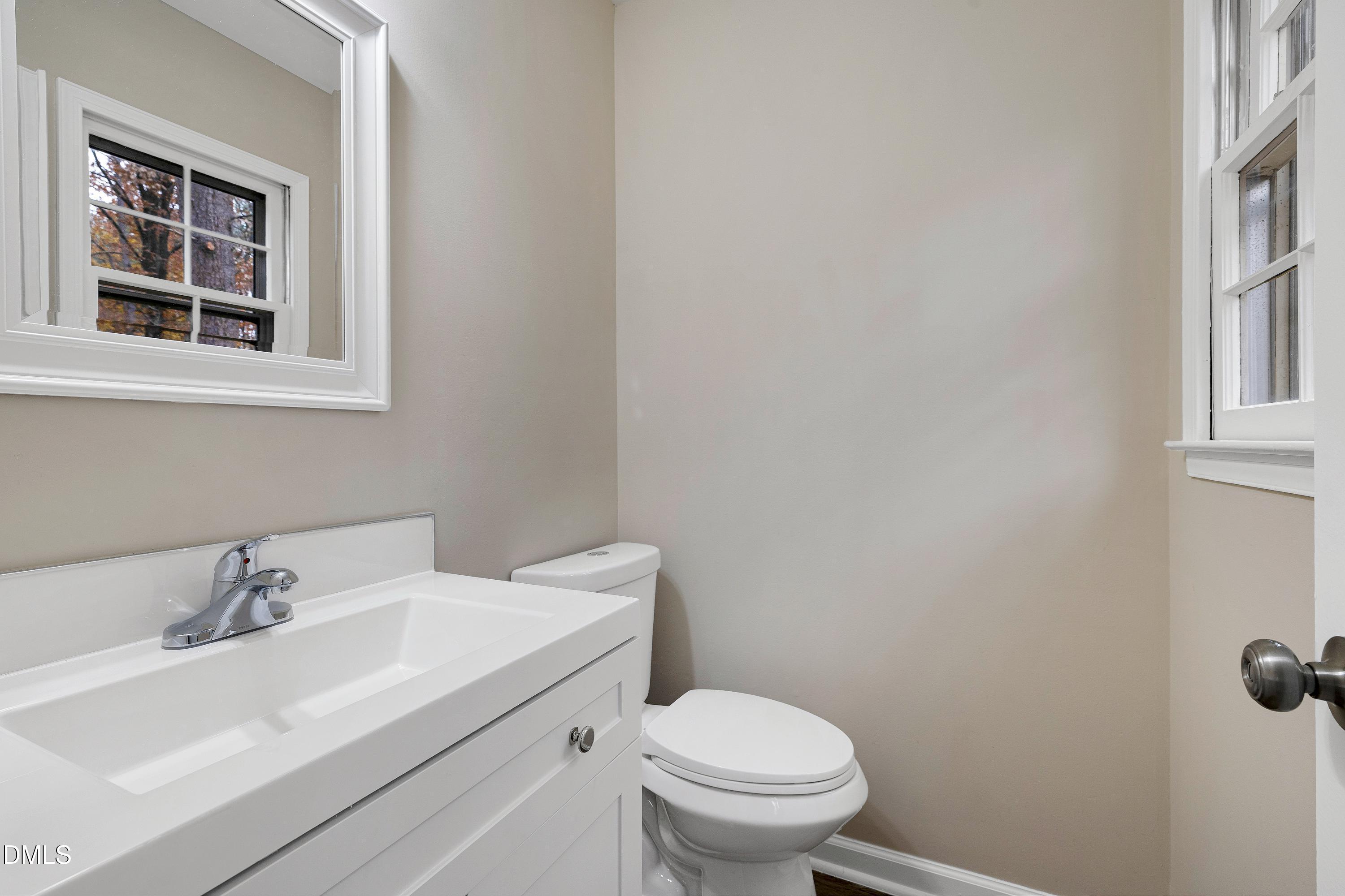 7812 Hemlock Court Raleigh, NC 27615 - Photo 15 of 25 a bathroom with a sink toilet and a window