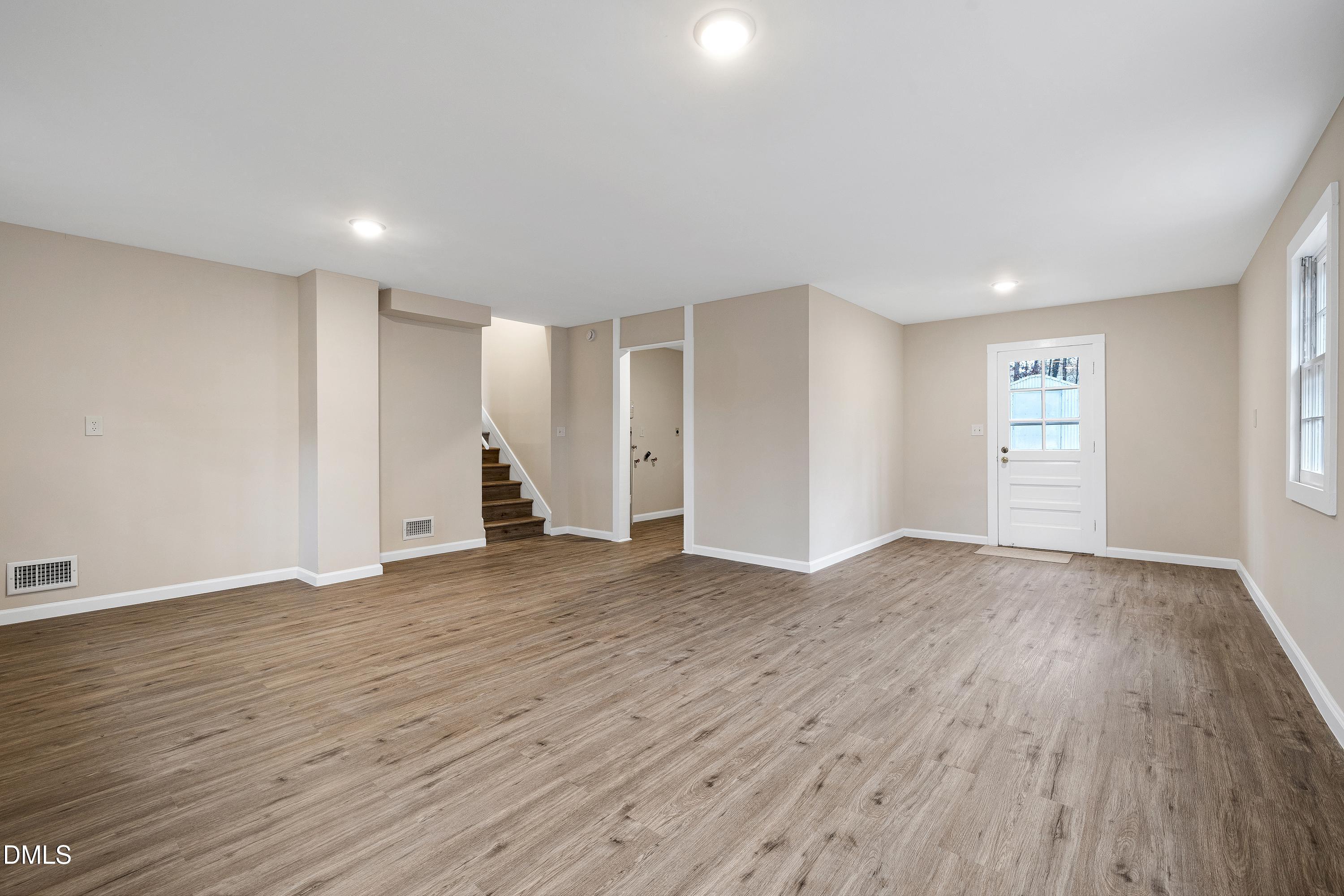 7812 Hemlock Court Raleigh, NC 27615 - Photo 17 of 25 a view of empty room with wooden floor and window