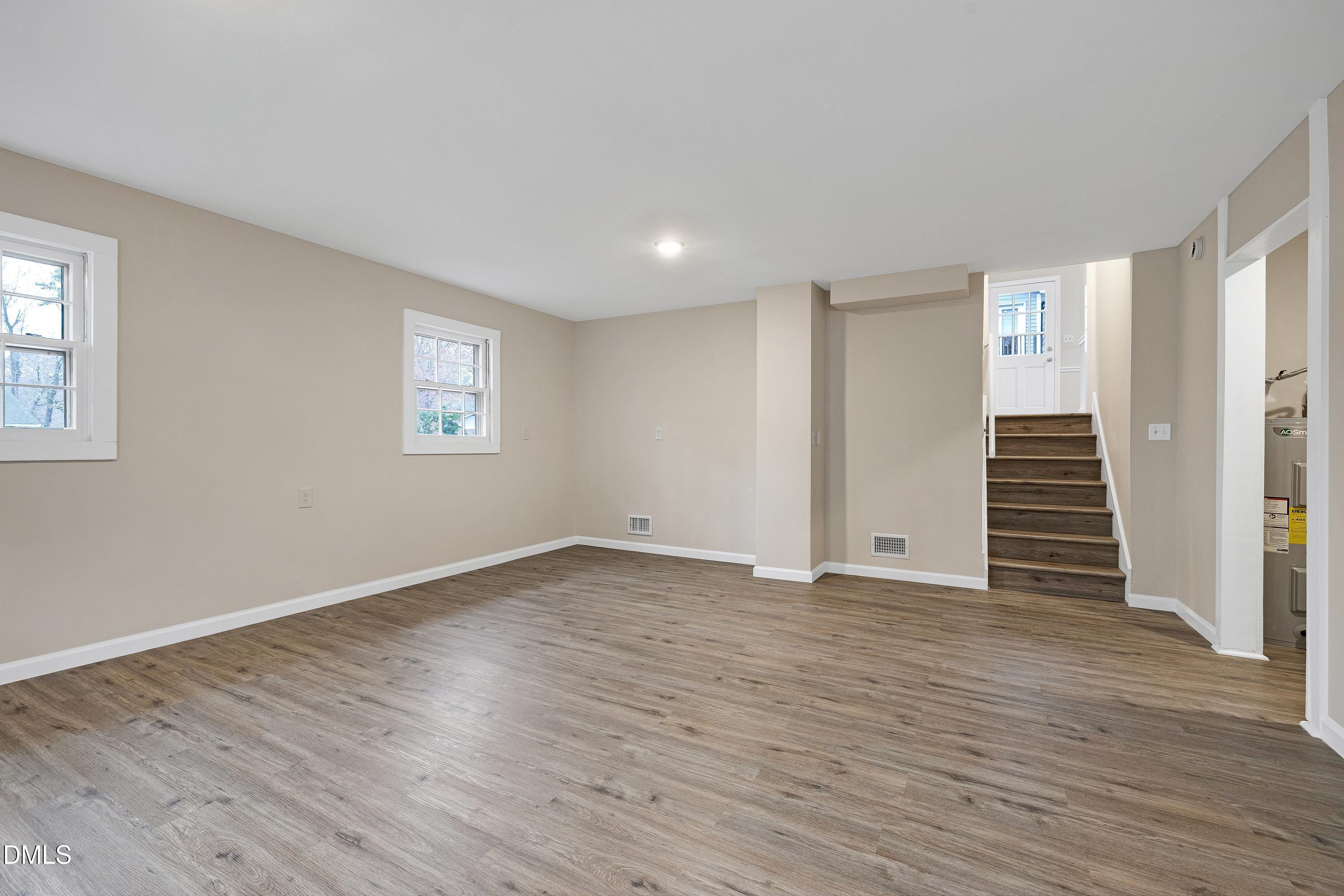 7812 Hemlock Court Raleigh, NC 27615 - Photo 19 of 25 a view of an empty room with wooden floor and window