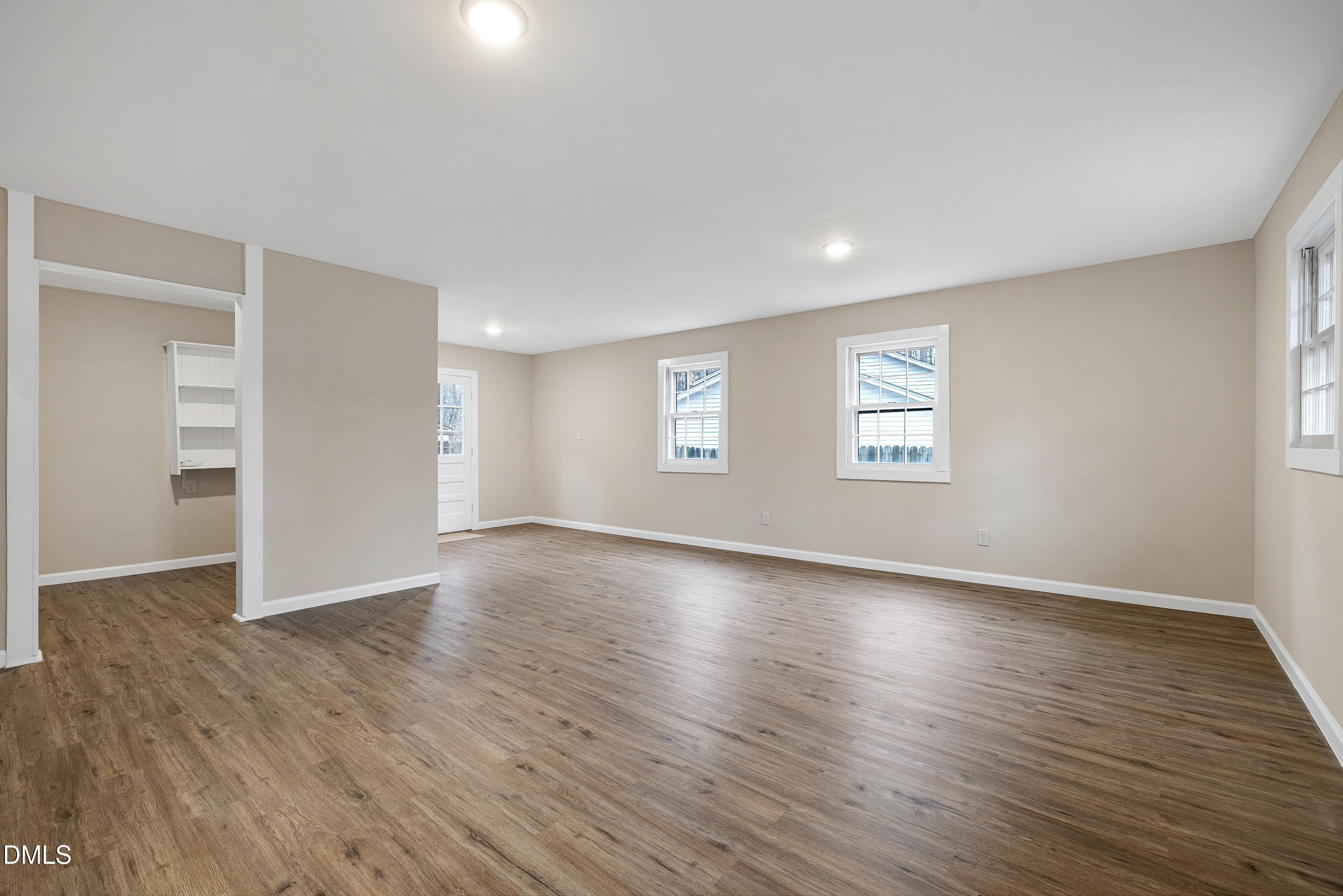7812 Hemlock Court Raleigh, NC 27615 - Photo 20 of 25 an empty room with wooden floor and windows