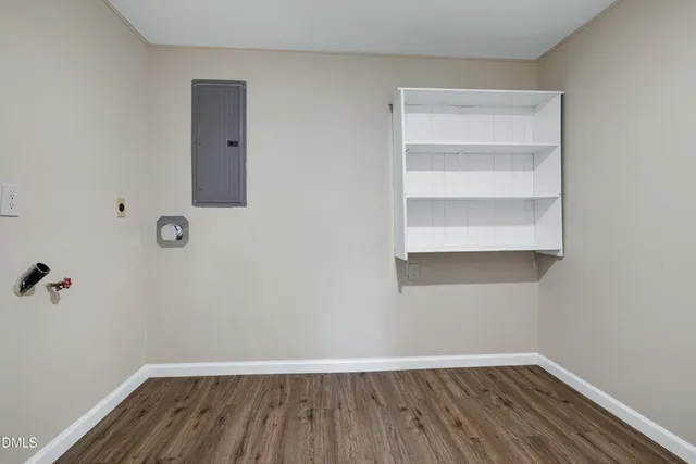 a view of a room with wooden floor