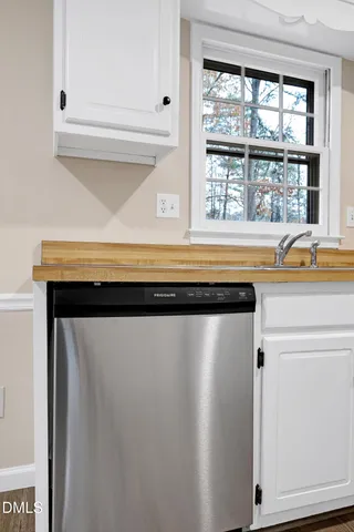 a view of a kitchen with a sink and a window