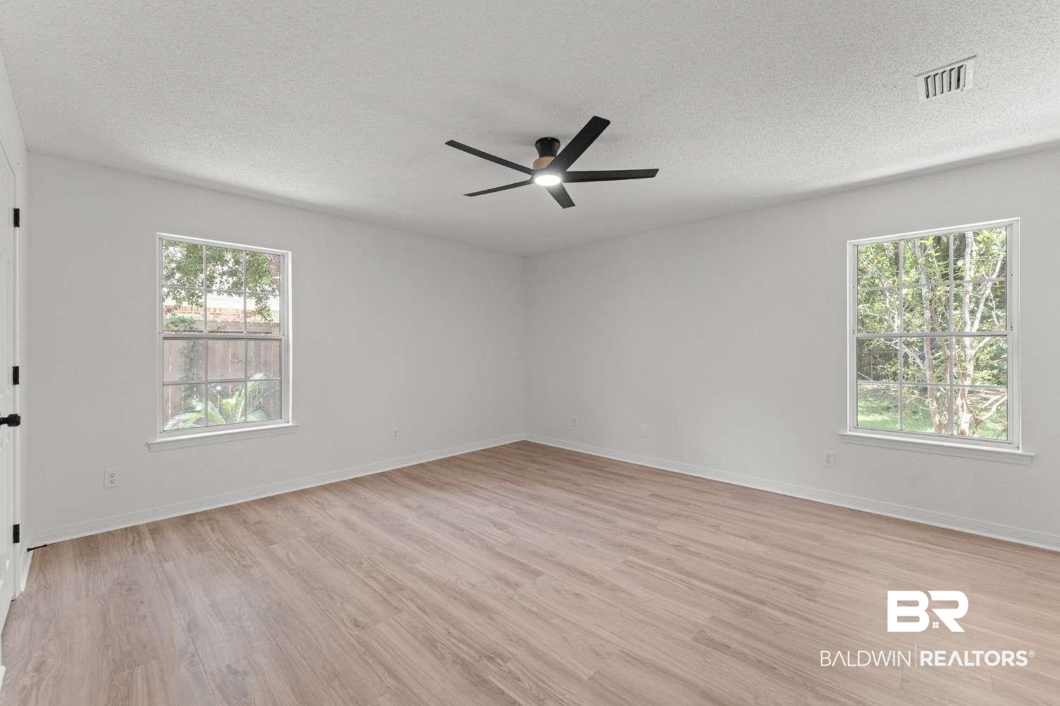 10251 Windmill Road Fairhope, AL 36532 - Photo 30 of 44 Empty room with ceiling fan, a textured ceiling, and light wood-style flooring