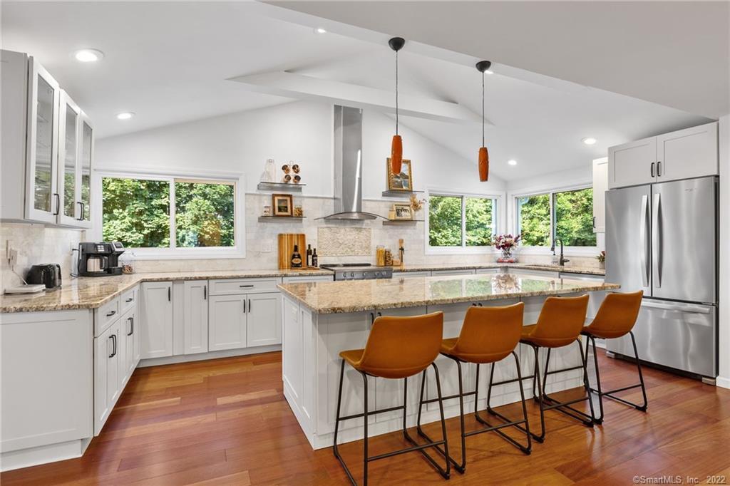 27 Meadowbrook Road Danbury, CT 06811 - Photo 1 of 1 a kitchen with stainless steel appliances granite countertop a stove a sink a refrigerator and white cabinets with wooden floor