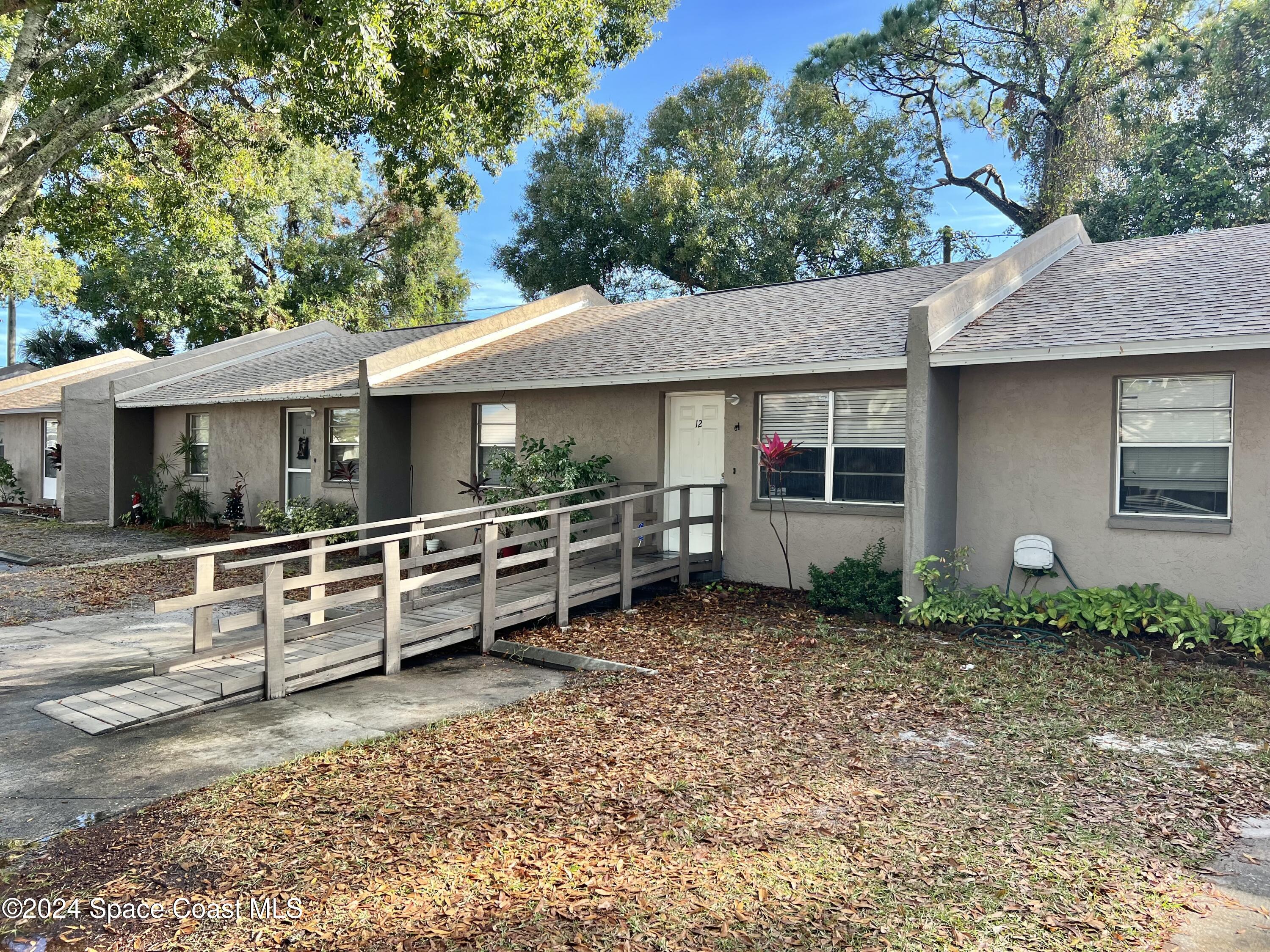 3225 Murrell Road, Unit 12 Rockledge, FL 32955 - Photo 1 of 14 a view of a house with a yard