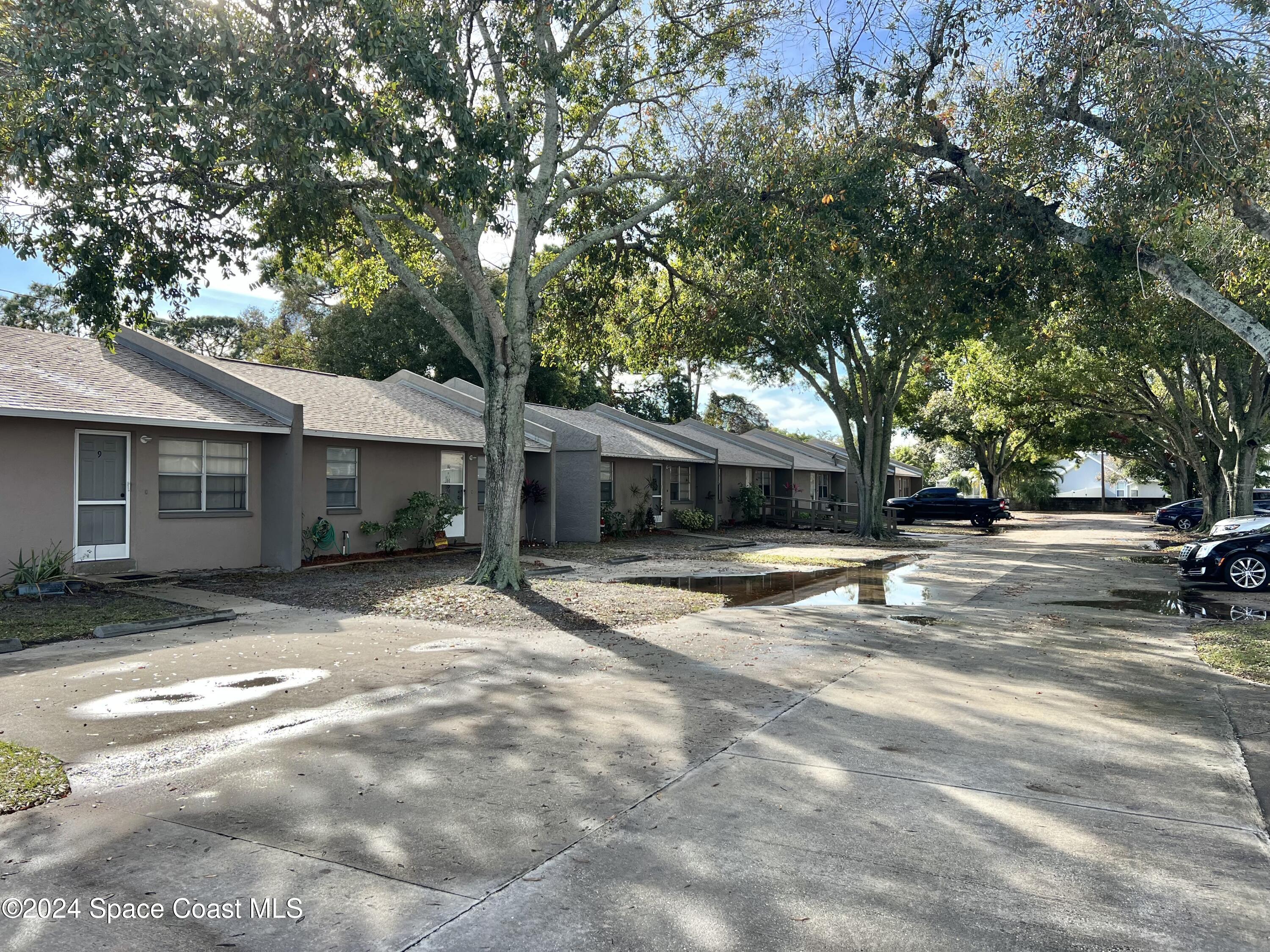3225 Murrell Road, Unit 12 Rockledge, FL 32955 - Photo 14 of 14 a view of a house with a yard and large tree